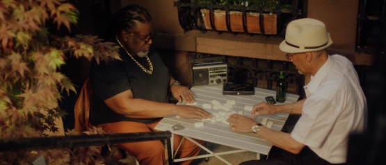 a group of people sitting at a table playing a board game